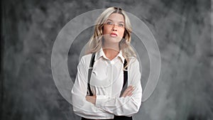 Portrait confident young blonde business woman leader boss employee posing isolated on gray studio