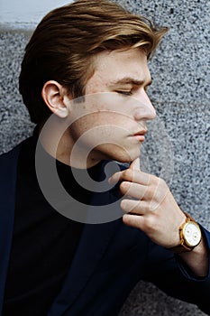 Portrait of confident young business man looking at camera with happy facial expression outdoors. Successful attractive caucasian