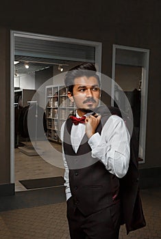 Portrait of a confident young business man looking to the side with a serious expression indoors. Successful attractive caucasian