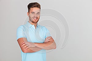 Portrait of confident young man wearing light blue polo t-shirt