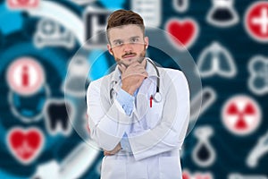 Portrait of confident young medical doctor on background with medical symbols.