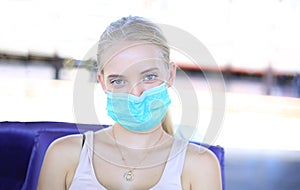 Portrait of confident young woman traveling by train, and wear protective face mask to prevent the spread of coronavirus, Covid-19