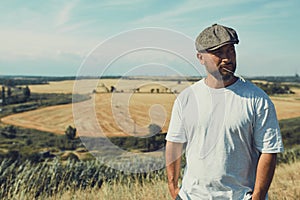 Portrait of confused male farmer looking into the camera and scratching his head. Close up of young doubtful man standing in the