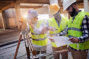 Portrait of construction engineers working on building site