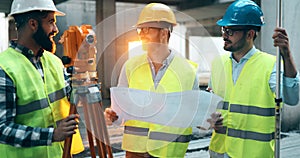 Portrait of construction engineers working on building site