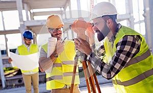 Portrait of construction engineers working on building site