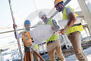 Portrait of construction engineers working on building site