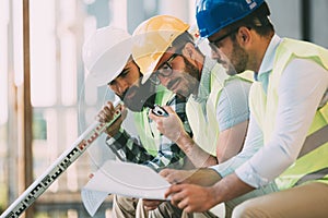 Portrait of construction engineers working on building site