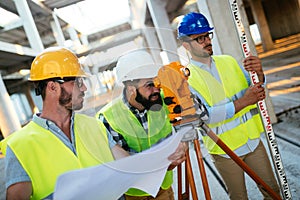 Portrait of construction engineers working on building site