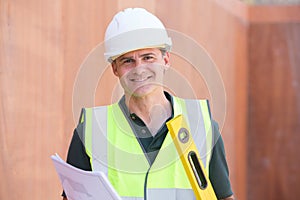 Portrait Of Construction Worker On Building Site With House Plan