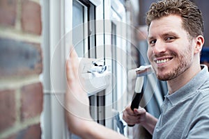 Portrait Of Construction Worker Installing New Windows In House