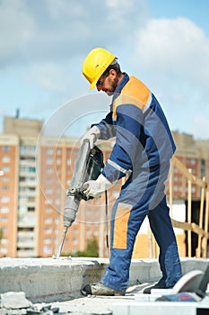 Portrait of construction worker with perforator photo