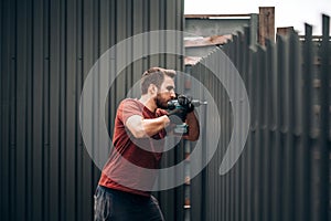 Construction worker using screwdriver for fastening and drilling