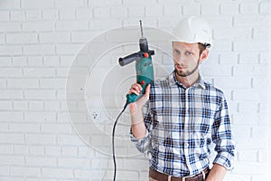 Portrait of a constructor holding a drill