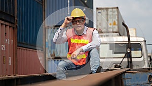 Portrait of containers yard and cargo inspector on container truck working outdoors with background of stacked containers
