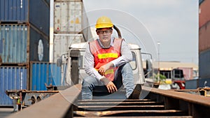 Portrait of containers yard and cargo inspector on container truck working outdoors with background of stacked containers