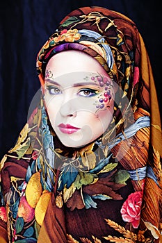 Portrait of contemporary noblewoman with face art creative