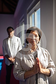 Portrait of content Asian yoga coach in gym