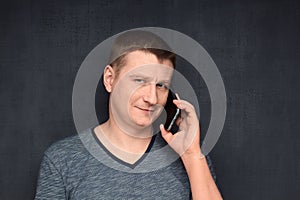 Portrait of contented and confident man speaking on phone