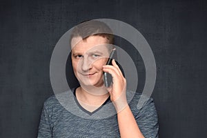 Portrait of contented man speaking on phone