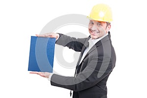 Portrait of contractor wearing hardhat holding blue cardboard