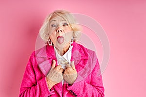 Portrait of cool careless carefree granny having fun free time leisure isolated pink background