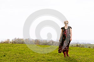Portrait of cool fashionable woman wearing dress boots and shade