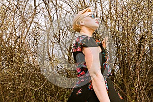 Portrait of cool fashionable woman wearing dress and shades