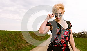 Portrait of cool fashionable woman wearing dress and shades