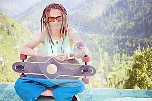 Portrait of cool, funny handsome man with skateboard