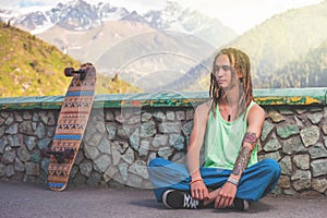 Portrait of cool, funny handsome man with skateboard