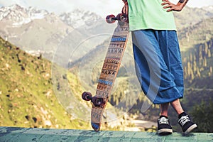 Portrait of cool, funny handsome man with skateboard