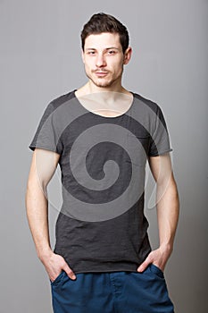 Cool male fashion model against gray background