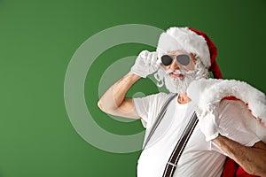 Portrait of cool Santa Claus on color background