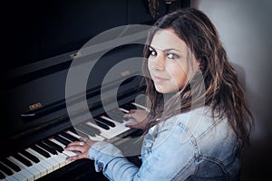 Portrait of cool teenage girl playing the piano