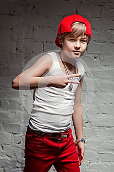 Portrait of cool young hip hop boy in red hat and red pants