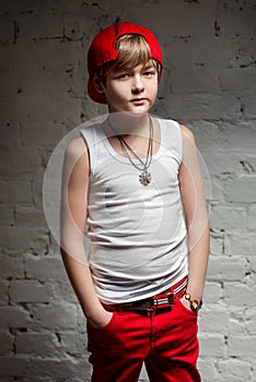 Portrait of cool young hip hop boy in red hat and red pants