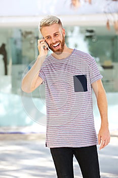Cool young man with beard talking on mobile phone
