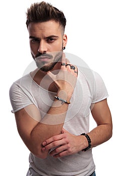 Portrait of a cools guy holding hand on neck