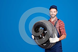 Portrait with copy space, empty place for advertisement of joyful cheerful mechanic in blue overall, shirt having