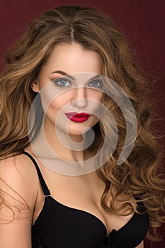 Portrait of coquette young curly woman with red lips