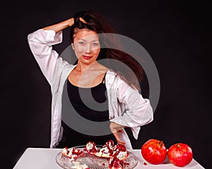 Portrait of a coquettish Asian woman with pomegranates