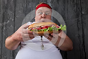 Portrait of corpulent guy going to eat sandwich