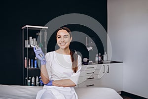 portrait of a cosmetologist with a dermapen device photo