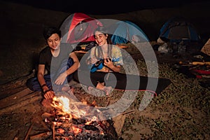 Portrait couple camping, enjoy the night with guitar a sing a so