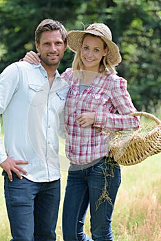 Portrait couple carrying wicker basket