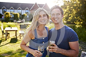 Portrait Of Couple Enjoying Outdoor Summer Drink At Pub