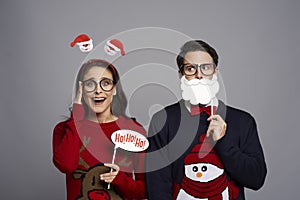 Portrait of couple with funny photo booth gadgets