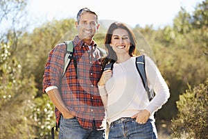 Portrait Of Couple Hiking In Countryside