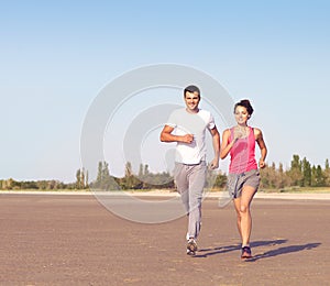 Portrait of couple jogging outside